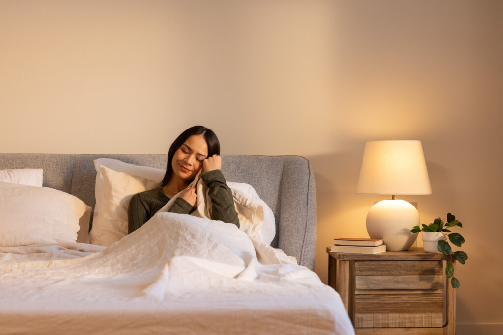 Woman enjoying comfy sheets on an Octave mattress