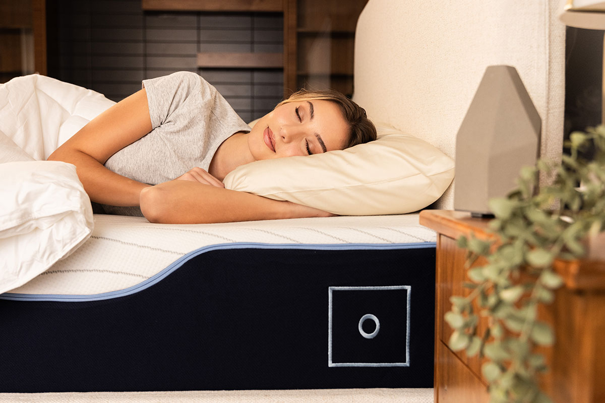 Woman peacefully sleeping on her side on an Octave Vista mattress.